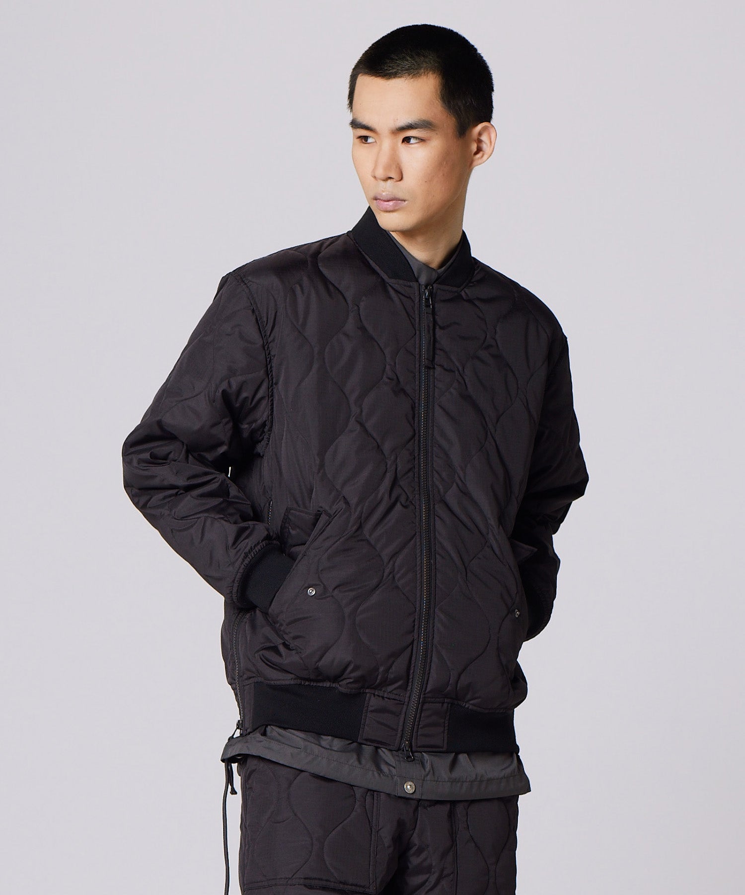 Model wearing Taion Military MA-1 Type Down Jacket in Black showing relaxed bomber fit and lightweight insulation