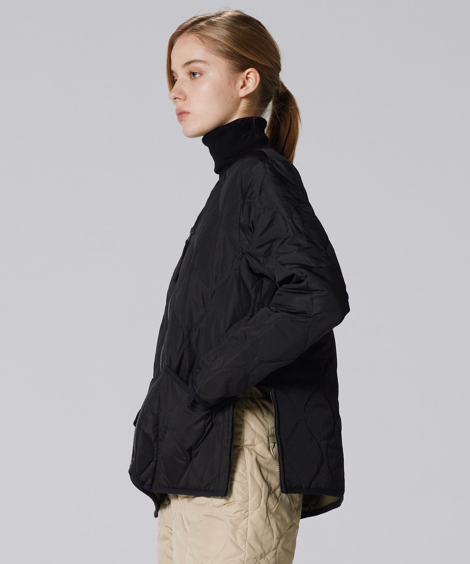 Model wearing Taion Military Zip V Neck Down Jacket in D.Olive showcasing lightweight insulation and military-inspired layering