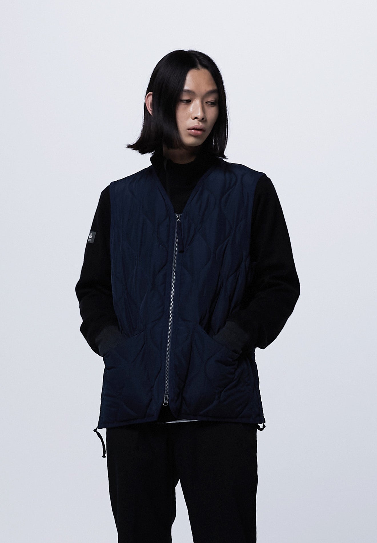 Side view of Taion Military Zip V Neck Down Vest in D.Navy