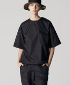 Model wearing Taion Non Down Military Half Sleeve Cut Sew in Black with lightweight fabric and relaxed everyday fit