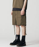 Model wearing Taion Non Down Military Reversible Shorts in Dark Olive with a relaxed fit for everyday wear