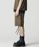Model wearing Taion Non Down Military Reversible Shorts in Dark Olive for versatile everyday comfort