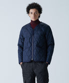 Model wearing Taion Unisex Military Zip V Neck Down Jacket in D.Navy