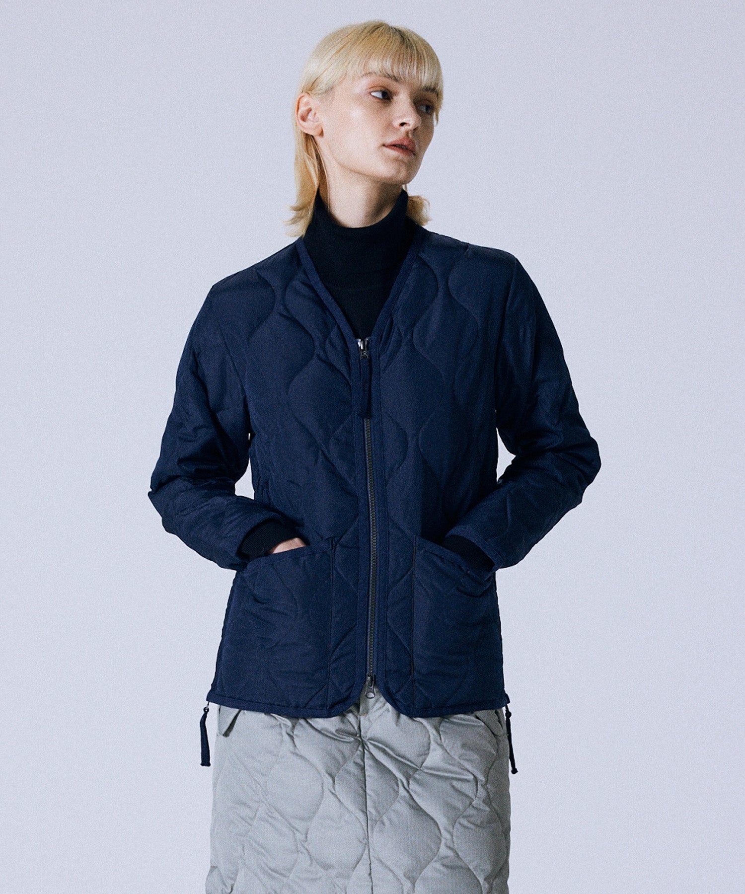 Model wearing Taion Unisex Military Zip V Neck Down Jacket in D.Navy